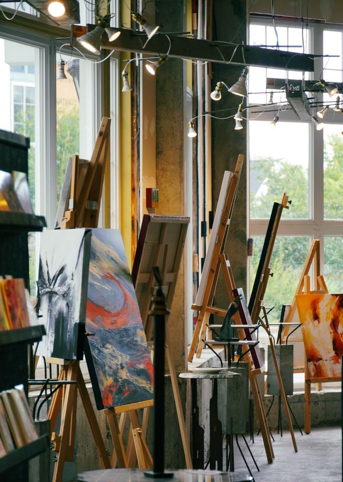 Home A vibrant art studio with easels and paintings showcasing creativity and design.