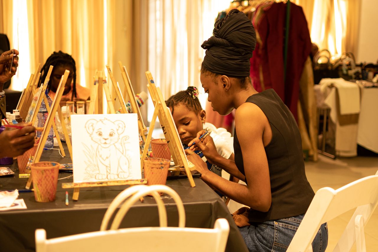 Home A dedicated mother paints with her child in an art workshop, fostering creativity together.